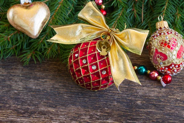 Red christmas ball with golden bow — Stock Photo, Image
