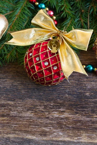 Red christmas ball with golden bow — Stock Photo, Image