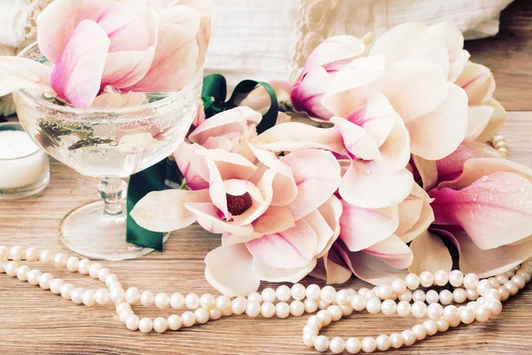 Fiori di magnolia con perle su tavola di legno — Foto Stock