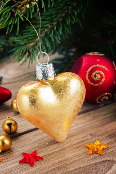 Golden heart on fir tree — Stock Photo, Image