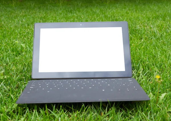 Tablet with keyboard on fresh grass — Stock Photo, Image