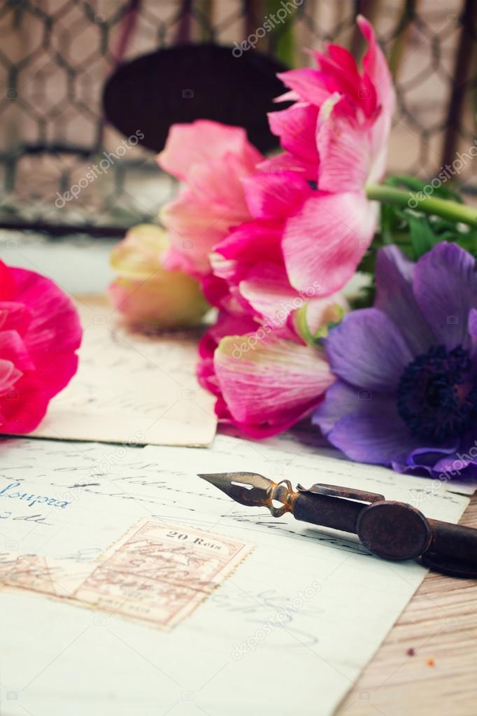 quill pen and antique letters with anemone flowers