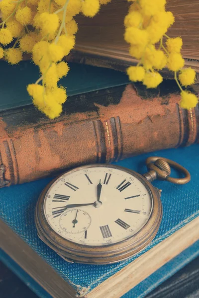 Pile of old books with pocket watch — Stock Photo, Image