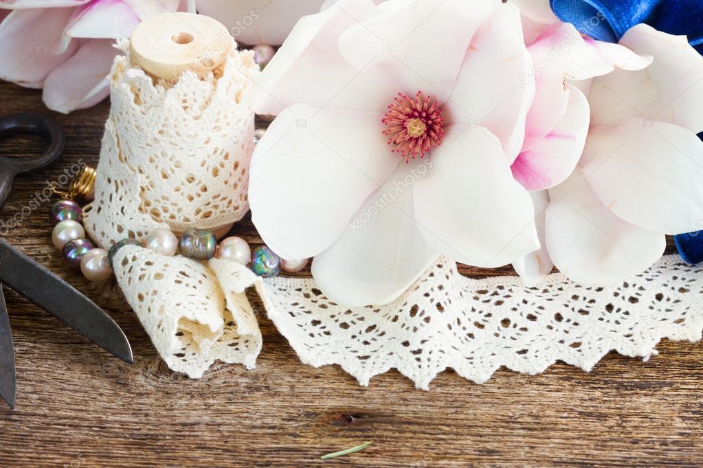 magnolia flowers with pearls on wooden table