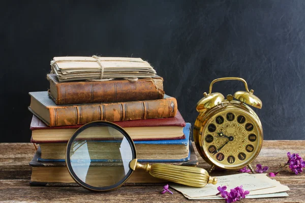 Pile of books with clock — Stock Photo, Image