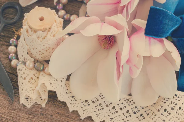 Magnolia flores con perlas sobre mesa de madera — Foto de Stock