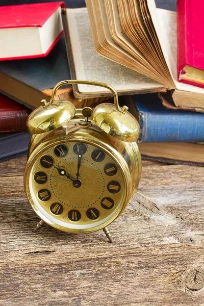 Pile of books with clock — Stock Photo, Image