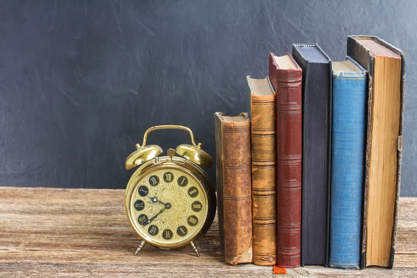 Pile of books with clock — Stock Photo, Image