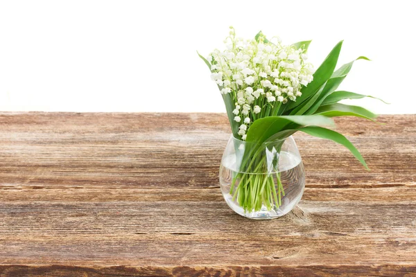 Maiglöckchen auf Holz — Stockfoto