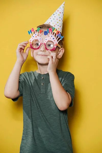 Cute ten year old birthday boy standing in front of the wall — Stock Photo, Image