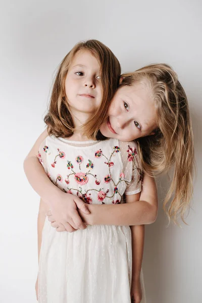 Brother hugging sister from behind. Siblings of elementary school age together — Stock Photo, Image