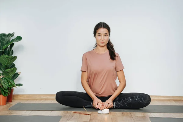 Smug woman practicing yoga, doing butterfly asana, turnig soles upward — Stock Photo, Image