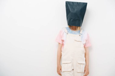 Young girl hid from the problems by putting a bag over her head and was offended clipart
