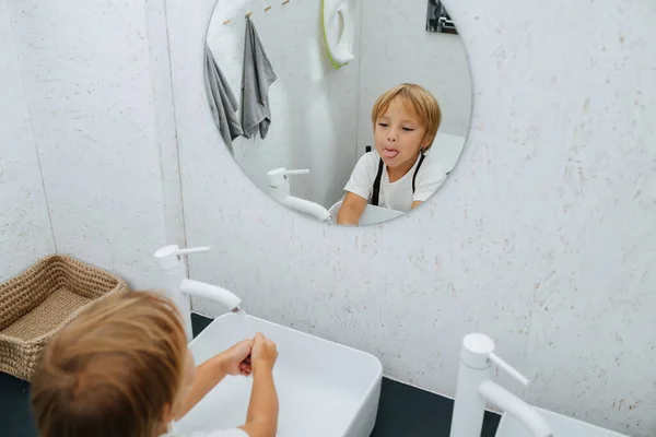 Grimacing Mirror Little Boy Washing His Hands Bathroom Sink Sticking — Stock Photo, Image