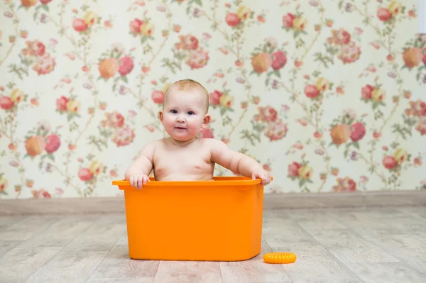 Portrait of a child sitting in box — Stock Photo, Image