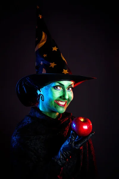 Wicked witch with apple — Stock Photo, Image