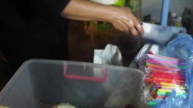 Kadın Bangkok Tayland 'da büyük bir bıçakla hindistan cevizi soyuyor.