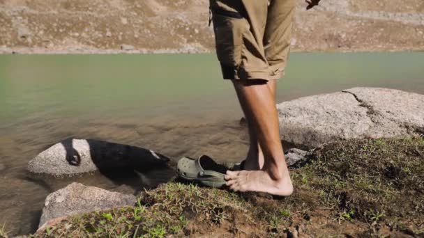 Турист отдыхает на горном озере — стоковое видео