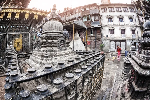 Woman sweeping in the temple — Stock Photo, Image