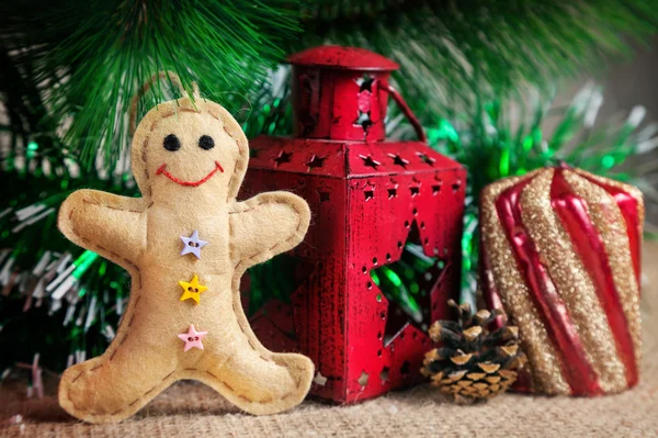 Gingerbread toy near Christmas tree — Stock Photo, Image