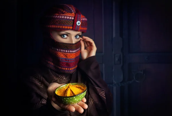 Woman in turban with yellow spice — Stock Photo, Image