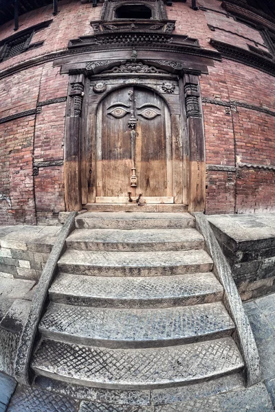 Wooden door with eyes — Stock Photo, Image