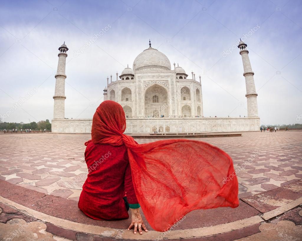 Woman in red near Taj Mahal 
