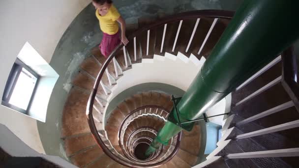 Woman going down by spiral stairs — Stock Video