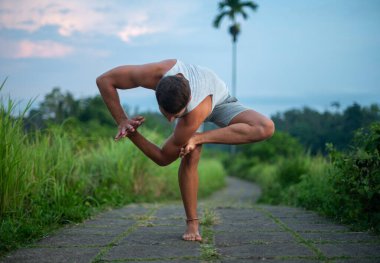 Erkek, dışarıda yoga ve meditasyon pratiği yapıyor.