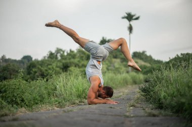 Erkek, dışarıda yoga ve meditasyon pratiği yapıyor.
