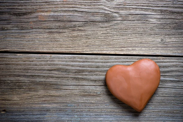 Clay heart on wood background — Stock Photo, Image