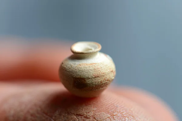 The smallest clay pot. pot on a potter's finger — Stock Photo, Image