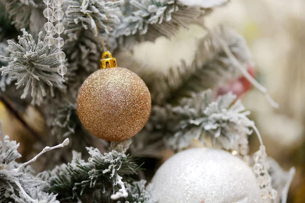 Christmas background with a gold ornament and fir in snow — Stock Photo, Image