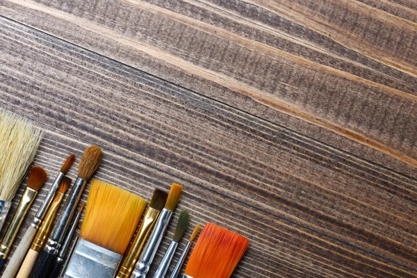 Brushes on wood background — Stock Photo, Image