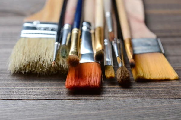 Brushes on wood background — Stock Photo, Image