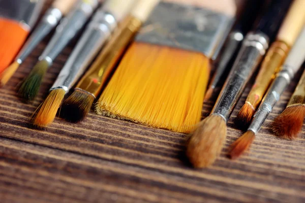 Brushes on wood background — Stock Photo, Image