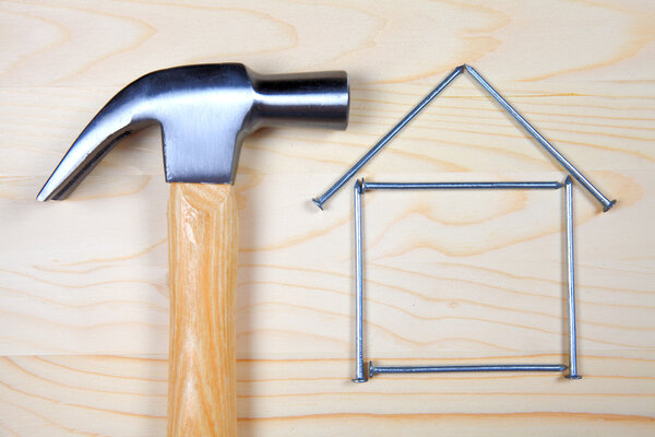 молоток и гвозди на деревянном фоне