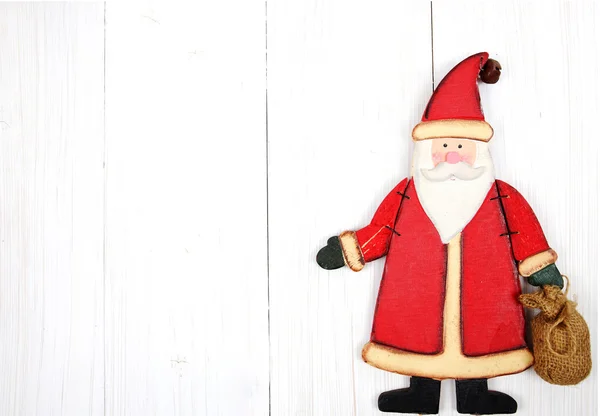 Tarjeta de Navidad. Santa Claus sobre fondo blanco de madera — Foto de Stock