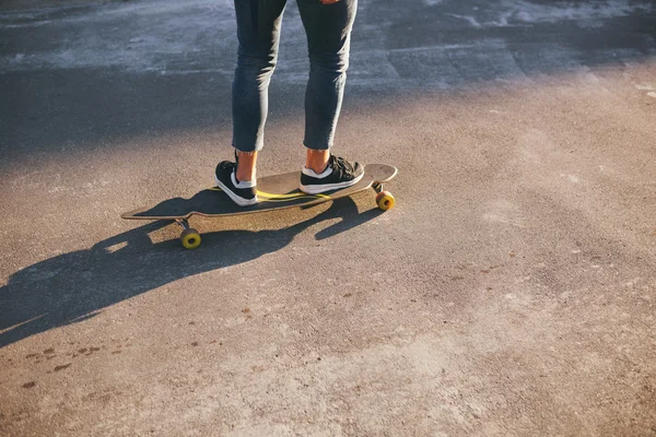 Image of a man with longboard going on road — Stock Photo, Image