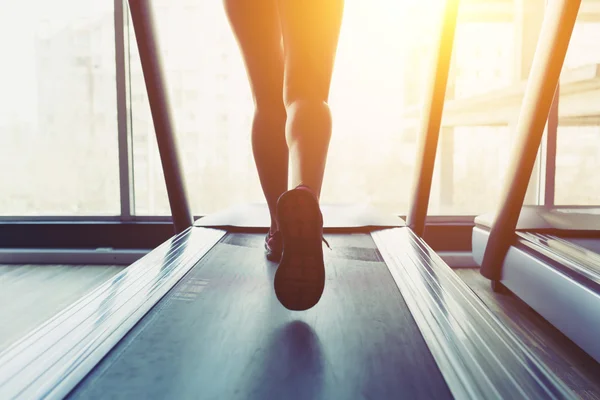 Fitness girl running on treadmill — Stock Photo, Image