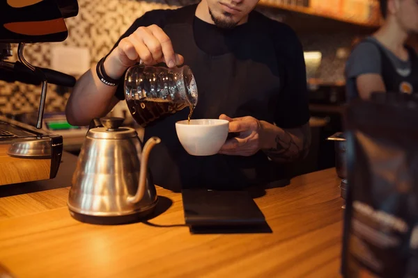 Barista at work in a coffee shop — Stock Photo, Image