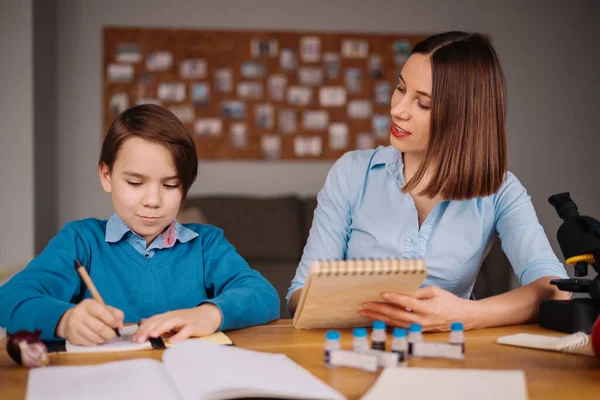 Home learning, woman and boy study at the table — Stock Photo, Image