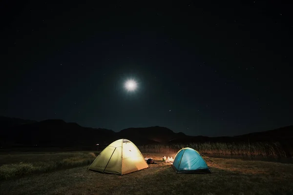 Tourist tents in camp among meadow in the night mountains — Stock Photo, Image