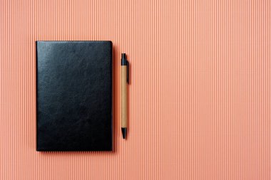 Soluk pembe arka planda deri defter kapağı