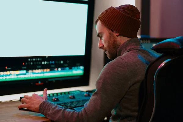 Male Video Editor Working on His Personal Computer with Big blank Display