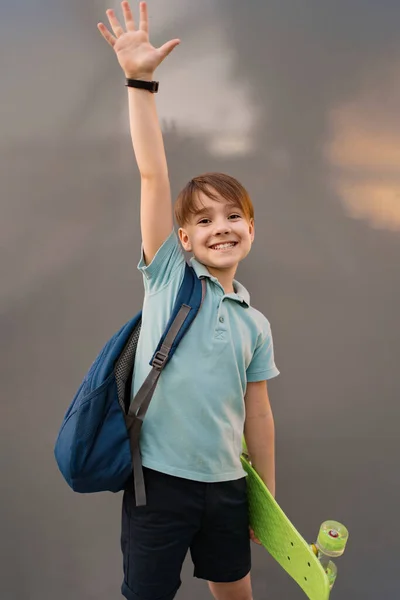 School boy holds a GREEN penny in his hands — Stock Photo, Image