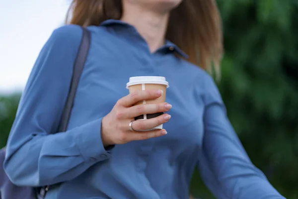 Vrouw in beweging met koffie buiten — Stockfoto