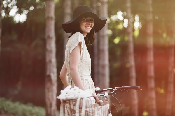 Girl on bicycle in forest — Stock Photo, Image