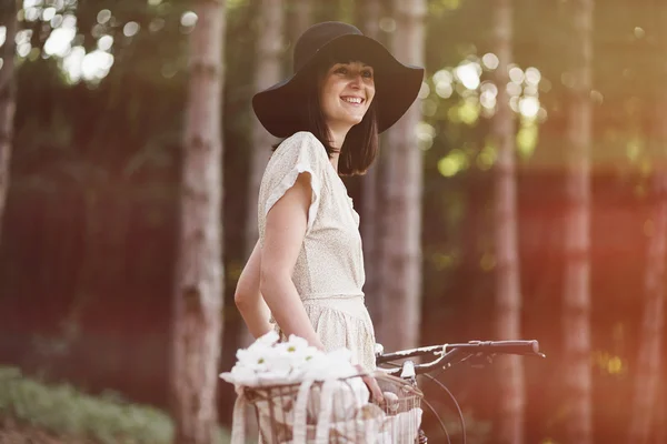 Girl on bicycle in forest — Stock Photo, Image