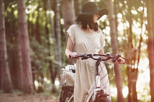 Girl on bicycle in forest — Stock Photo, Image